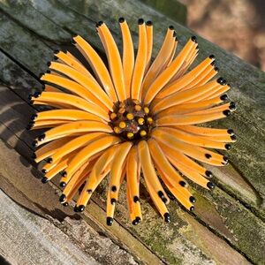 Orange & black enameled flower brooch